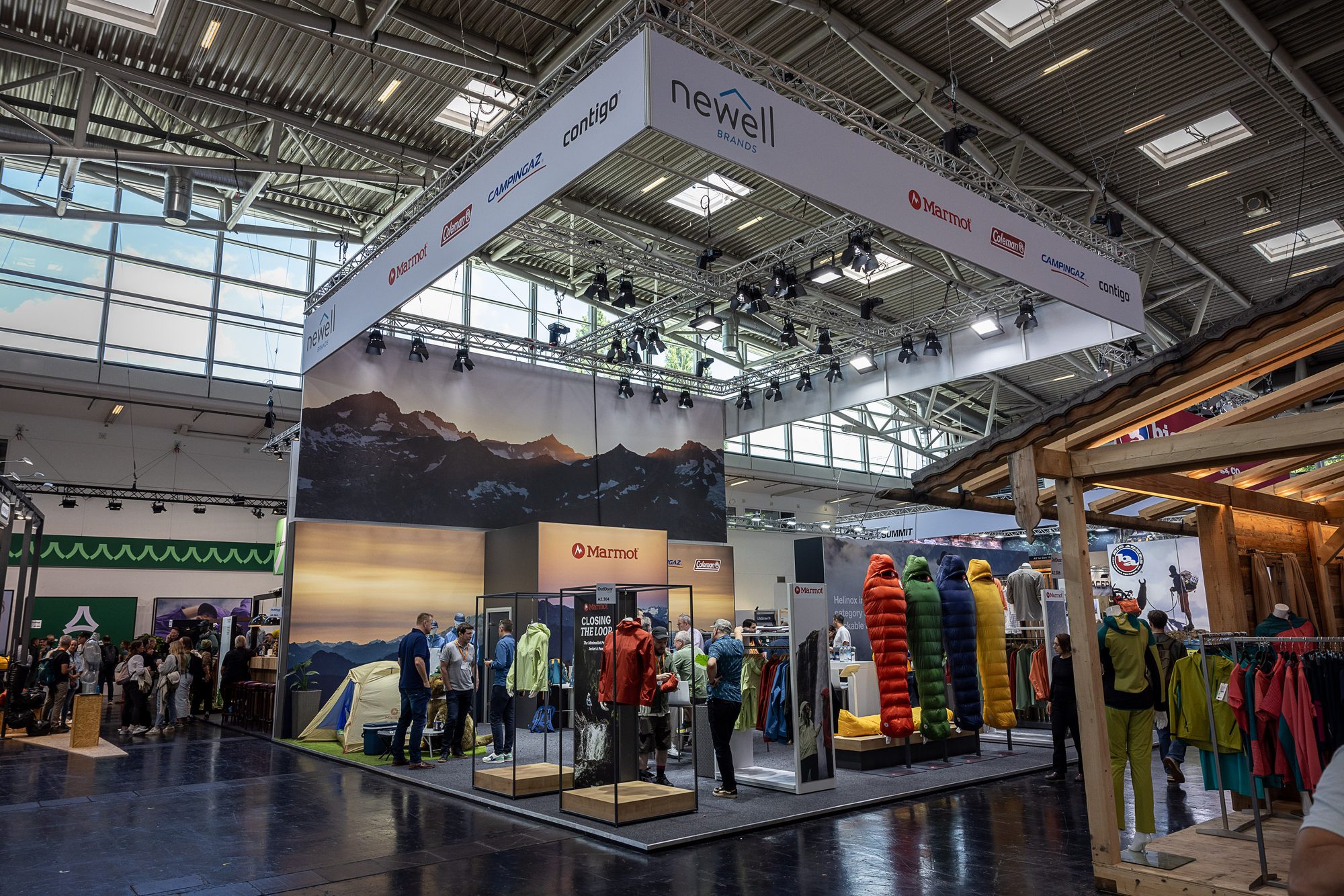 The Marmot booth at OutDoor by ISPO with tents and hanging jackets