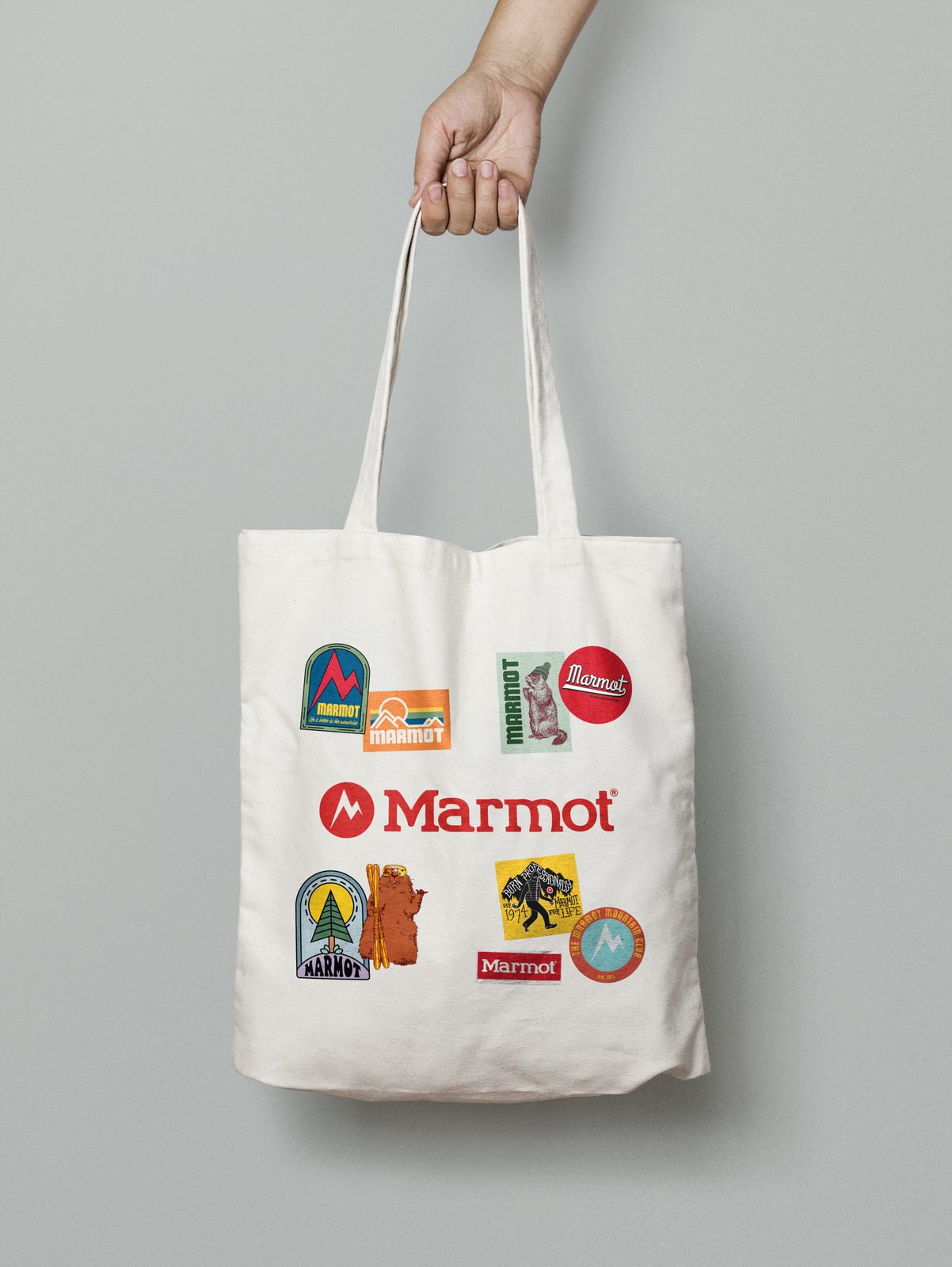 Tote bag covered in Marmot sticker designs