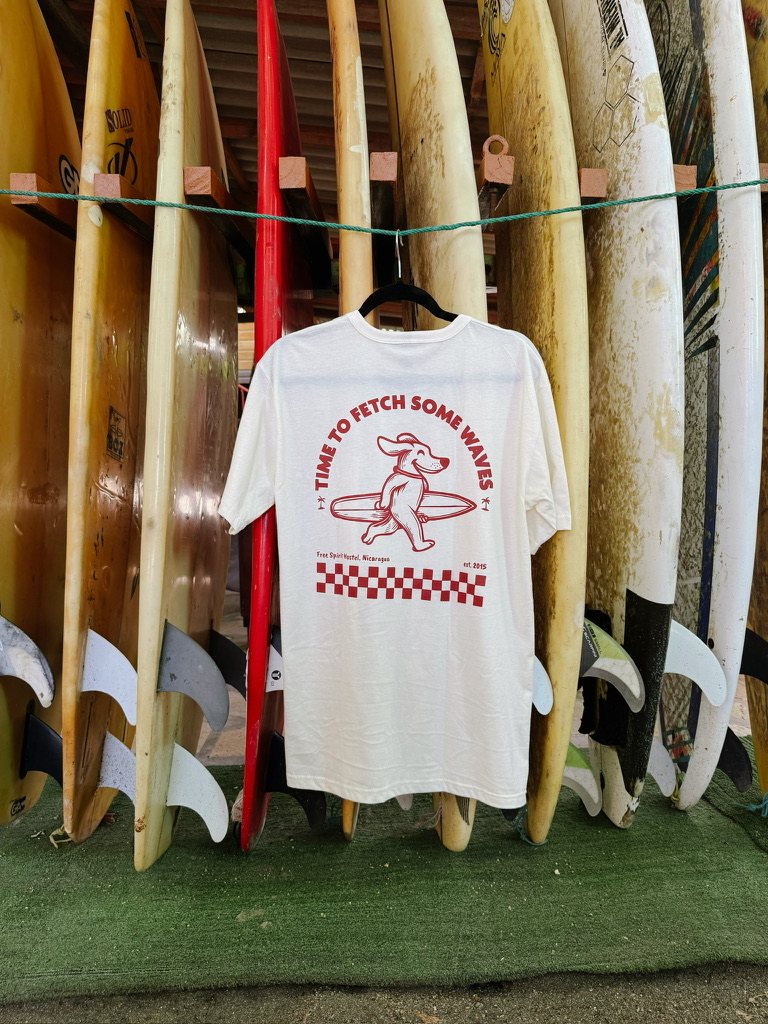 Shirt hanging between surfboards, back print with the surfing dog